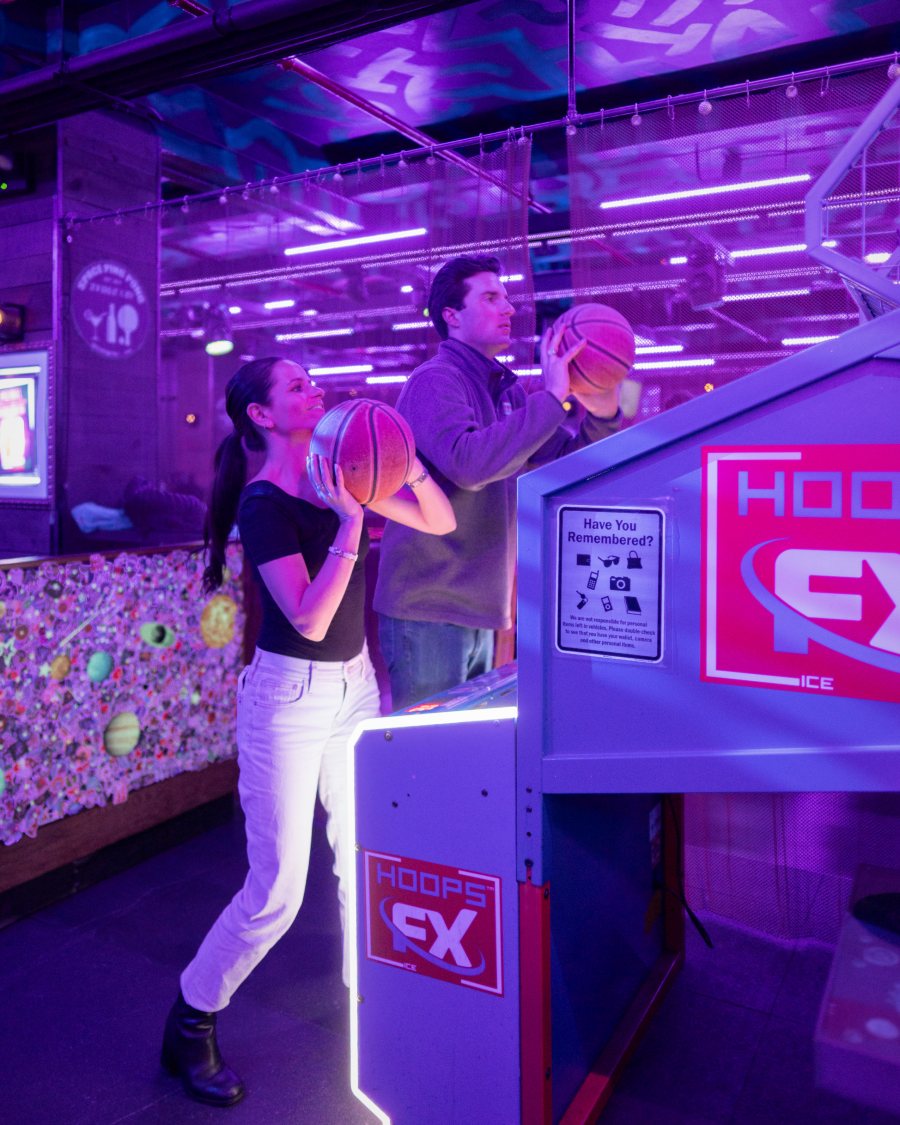 Guests shooting baskets on the Hoops FX arcade game