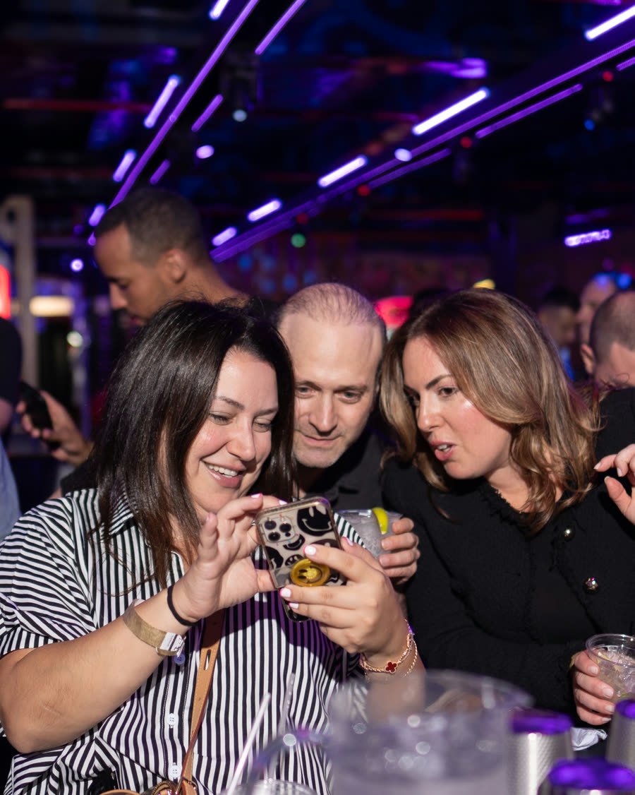 Guests laughing over drinks